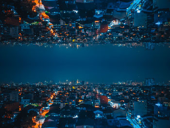 Directly below shot of illuminated buildings in city at night