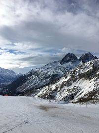 Scenic view of snowcapped mountains against sky