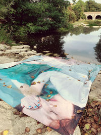 High angle view of woman relaxing by lake