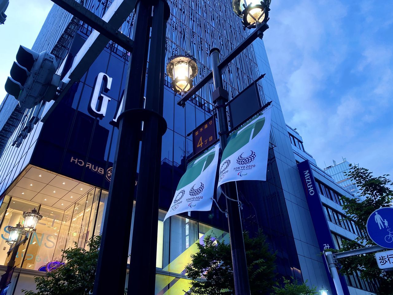 LOW ANGLE VIEW OF ILLUMINATED STREET LIGHT AGAINST BUILDINGS