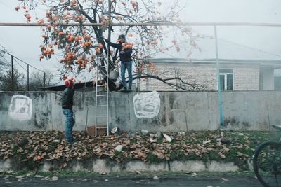 Side view of man standing by plants