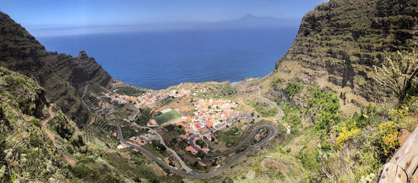 High angle view of sea and mountains against sky
