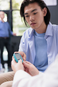 Portrait of young woman using mobile phone