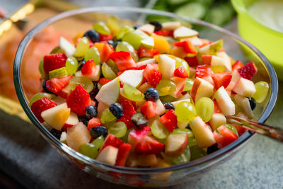 Colourful fruit salad in glass bowl