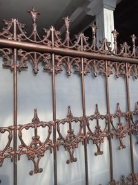 Close-up of metal fence against building