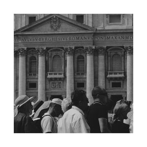 People at historic building against sky