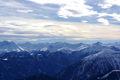 Scenic view of mountains against cloudy sky