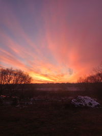 Scenic view of field against sky during sunset