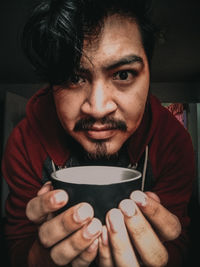 Portrait of young man drinking coffee