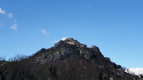 Low angle view of rocks against sky