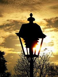 Low angle view of illuminated street light against sky during sunset