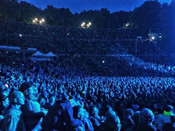 People enjoying music concert at night