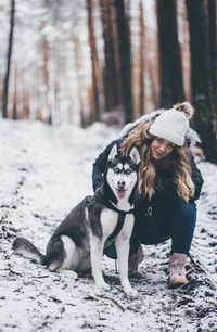 Full length of a dog on snow covered land