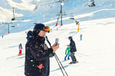 People skiing on snowcapped mountain