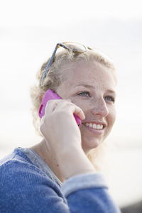 Smiling woman talking through phone