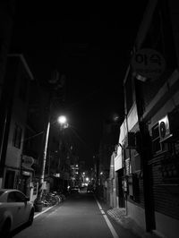 Cars on illuminated street at night