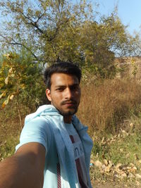 Portrait of young man standing on land