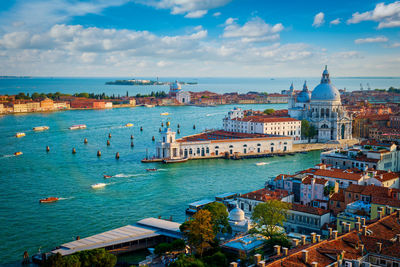 High angle view of townscape by sea against sky