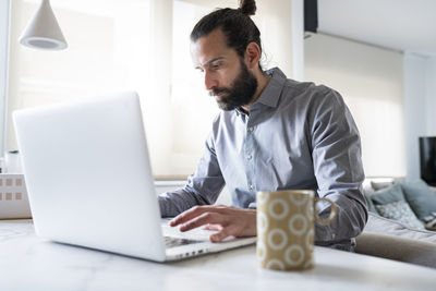 Man sitting on table at home