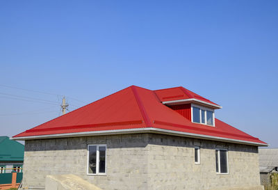 Low angle view of built structure against clear blue sky