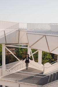 Man standing on staircase against sky