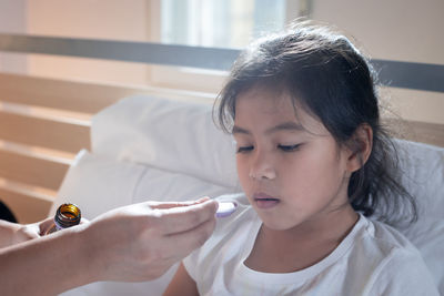 Close-up portrait of girl looking at home