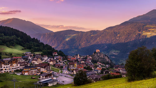 High angle view of townscape by mountain against sky