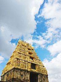 Low angle view of temple against cloudy sky