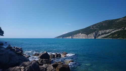 Scenic view of sea against clear blue sky