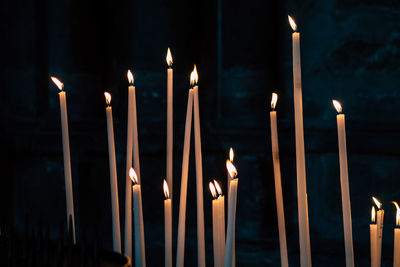 Close-up of illuminated candles in temple