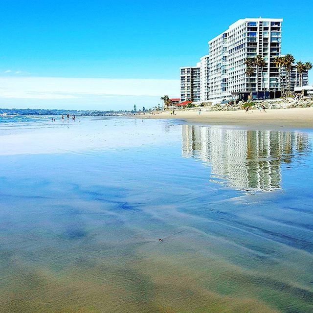 water, blue, building exterior, built structure, architecture, reflection, sea, waterfront, clear sky, sky, tranquility, tranquil scene, nature, day, city, outdoors, beauty in nature, scenics, beach, no people