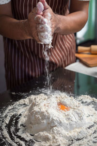 Midsection of person preparing food