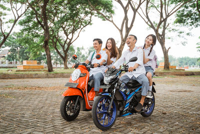 Man riding motor scooter on road