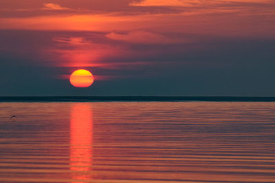 Scenic view of sea against orange sky