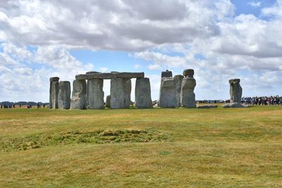 Built structure on field against cloudy sky