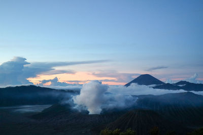 Aerial view of snowcapped bromo mountains against sky during sunrise
