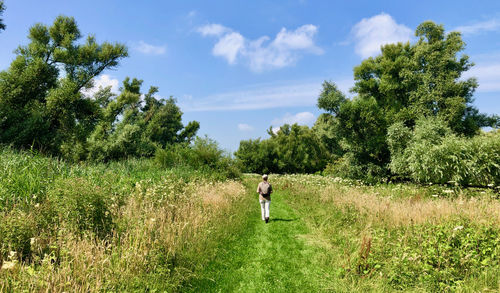 Man standing on field against sky