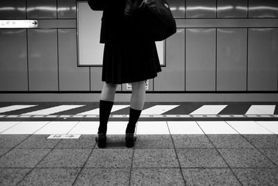 Low section of child standing on tiled floor