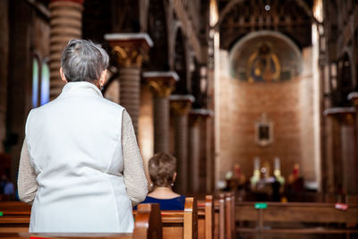 Senior woman praying at the historical cathedral of our lady of poverty of pereira, built in 1890