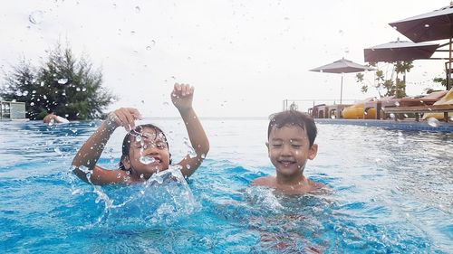 Portrait of happy boy swimming in pool