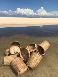 Wicker basket by water against sky