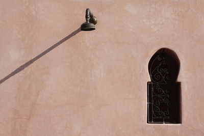 Shower head mounted on wall by window of riad