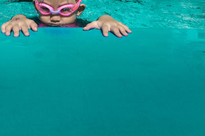 Portrait of boy swimming in pool