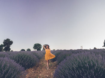 Rear view of woman standing against clear sky