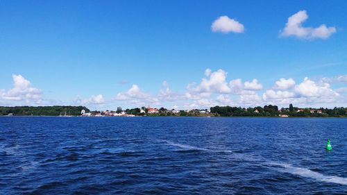 Scenic view of sea against blue sky