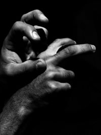 Cropped image of hand holding glass over white background