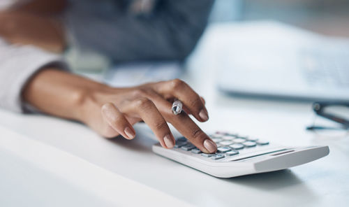 Midsection of businessman using laptop