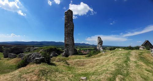 Scenic view of rocks on field against sky