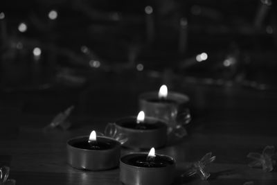 Close-up of lit tea light candles in temple