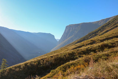 Scenic view of mountains against clear blue sky